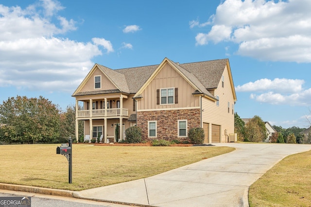 craftsman-style home with a garage, a balcony, and a front yard