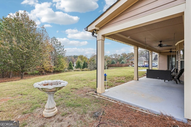 view of yard with ceiling fan and a patio