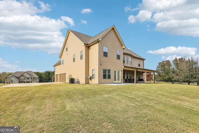 back of house with a lawn, cooling unit, a porch, and a garage