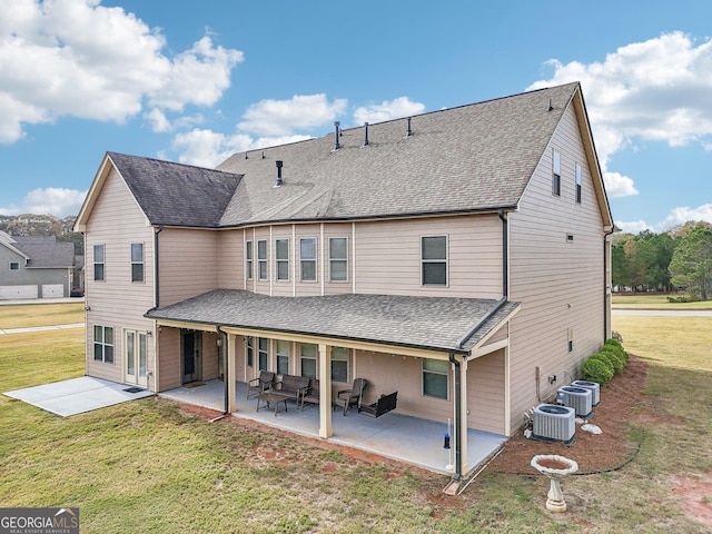 back of house with a patio, an outdoor hangout area, central AC unit, and a lawn