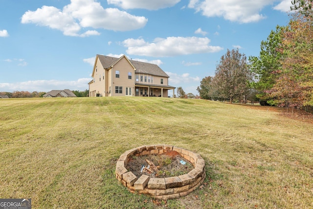 view of yard featuring an outdoor fire pit