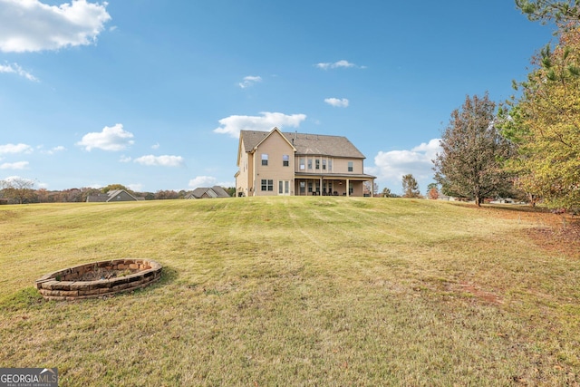 view of yard featuring a rural view and an outdoor fire pit