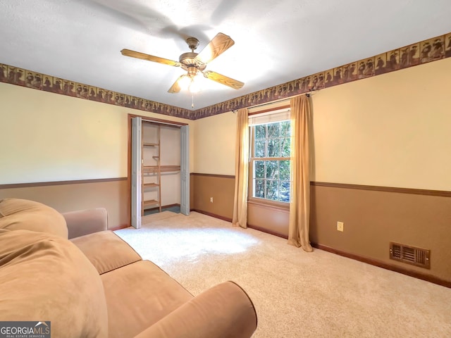 living room featuring carpet flooring and ceiling fan