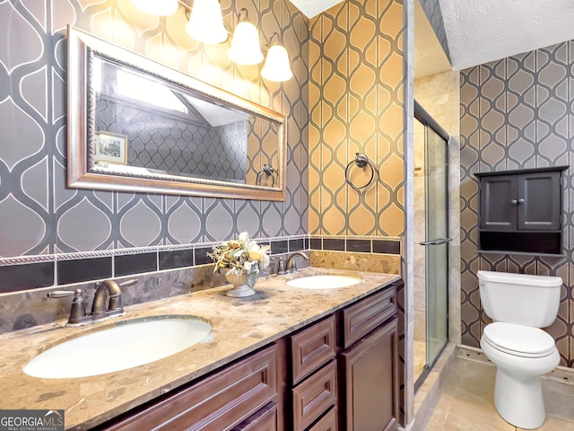 bathroom with tile patterned flooring, a textured ceiling, toilet, vanity, and a shower with shower door