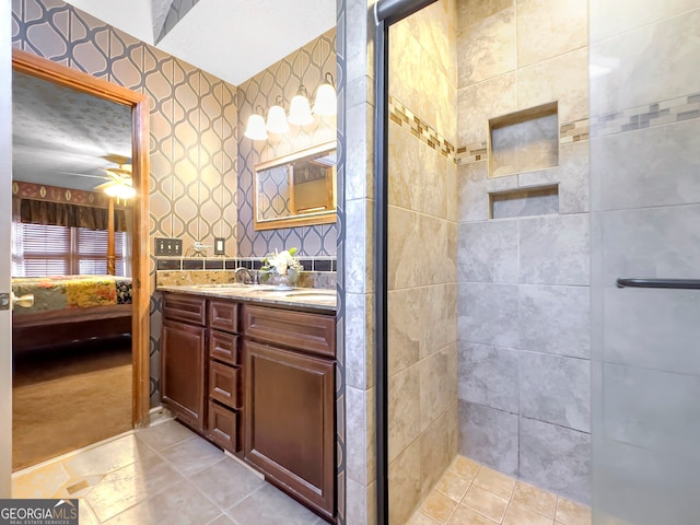 bathroom with vanity, ceiling fan, and a shower with door