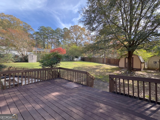 wooden deck with a storage shed and a lawn