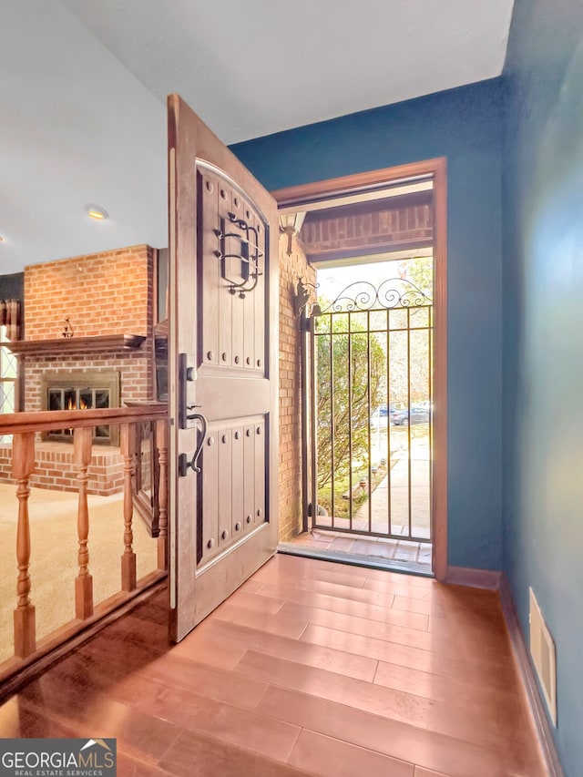 entryway featuring a fireplace and hardwood / wood-style floors