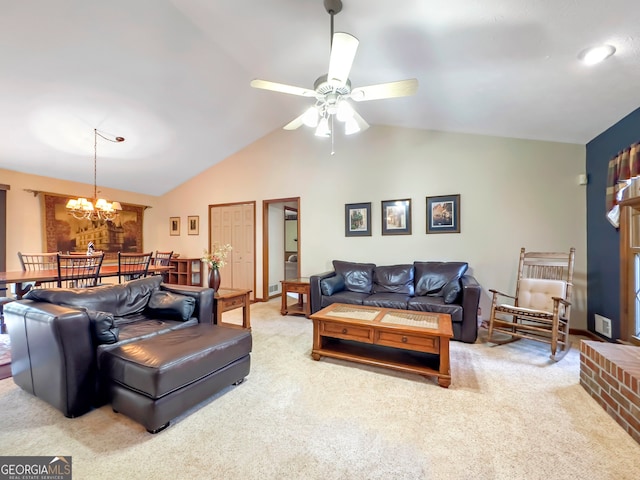 living room featuring ceiling fan with notable chandelier, carpet, and vaulted ceiling