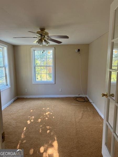 spare room featuring carpet and ceiling fan