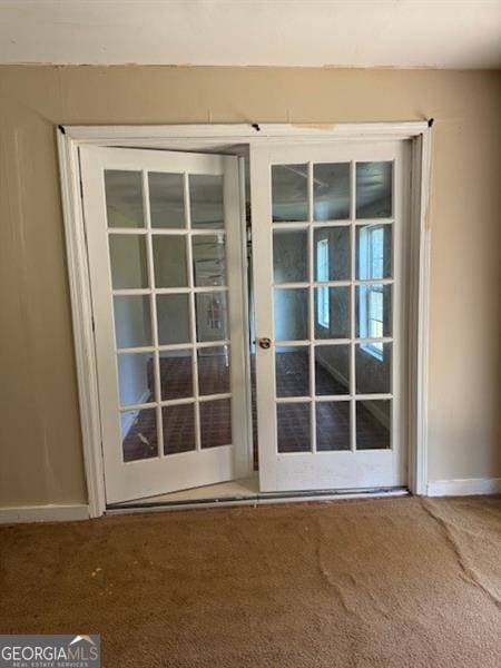 doorway featuring carpet and french doors