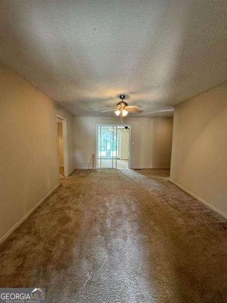 empty room with carpet flooring, a textured ceiling, and ceiling fan