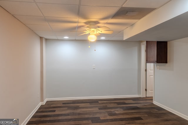 unfurnished room featuring a paneled ceiling, ceiling fan, and dark wood-type flooring