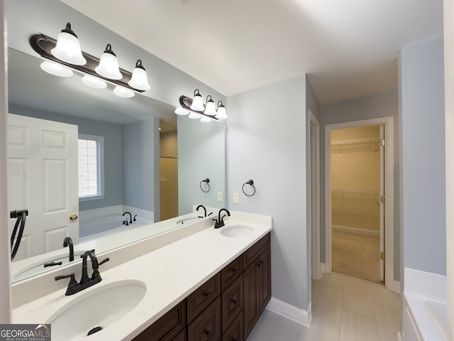 bathroom with tile patterned flooring, vanity, and a bathing tub