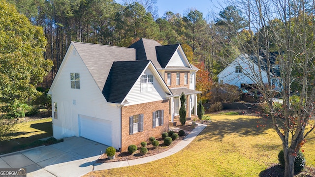 view of side of home featuring a lawn and a garage