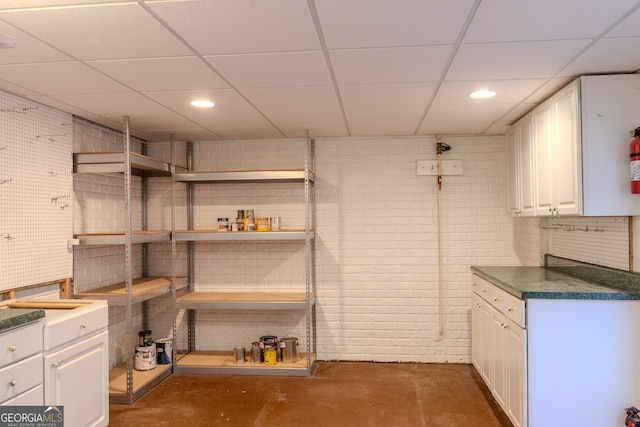 basement with a paneled ceiling