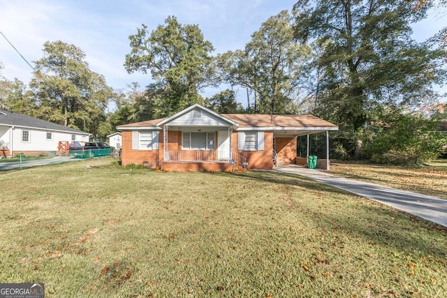 view of front of home featuring covered porch, a front yard, and a carport