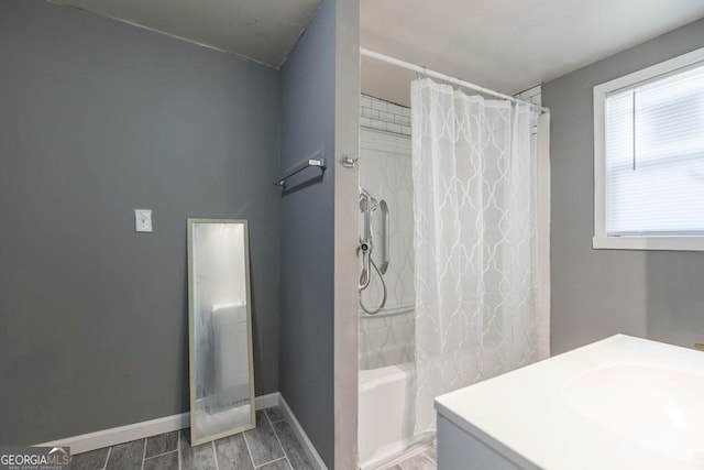 bathroom with sink, shower / bath combination with curtain, and hardwood / wood-style flooring