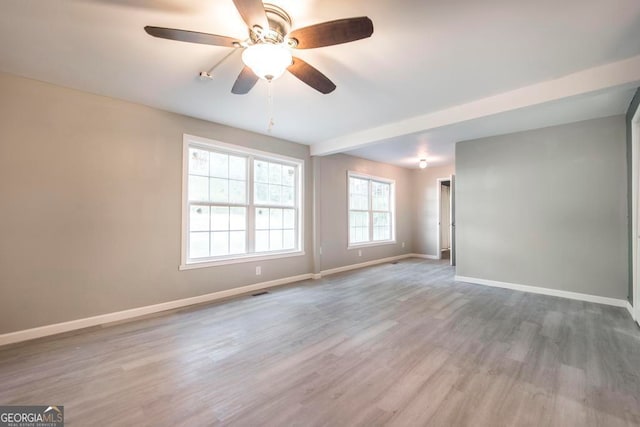 spare room with hardwood / wood-style floors and ceiling fan