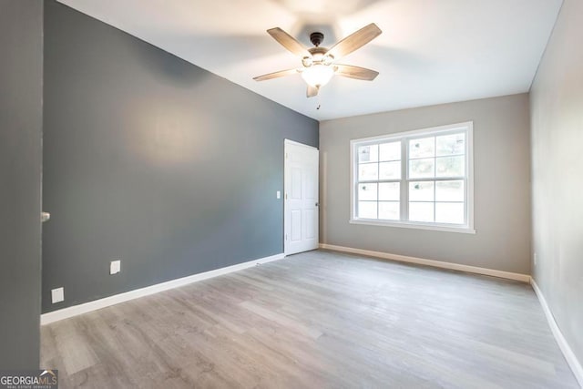 spare room with ceiling fan and light hardwood / wood-style flooring