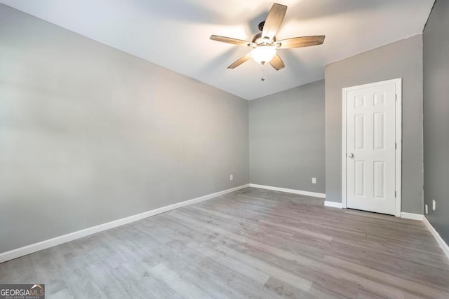 spare room with ceiling fan and light hardwood / wood-style flooring