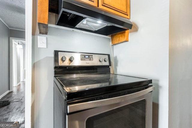 kitchen featuring wood-type flooring, electric stove, and a textured ceiling