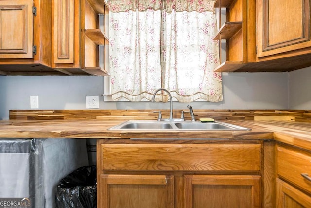 kitchen featuring wooden counters and sink