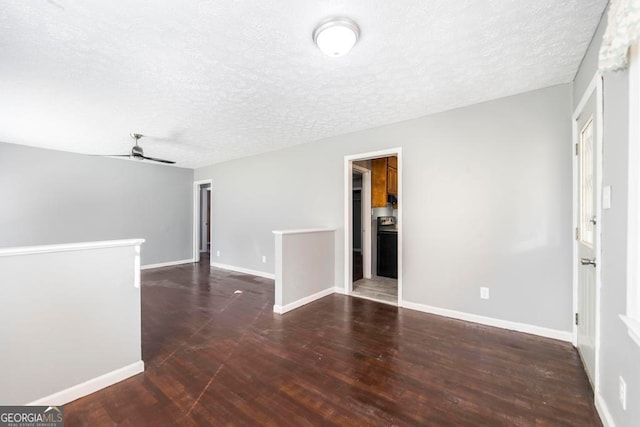 empty room featuring ceiling fan, dark hardwood / wood-style flooring, and a textured ceiling