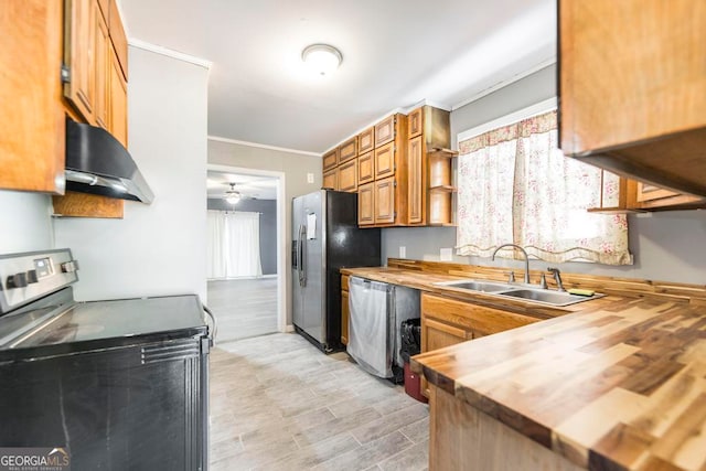 kitchen featuring wood counters, ventilation hood, sink, ceiling fan, and stainless steel appliances