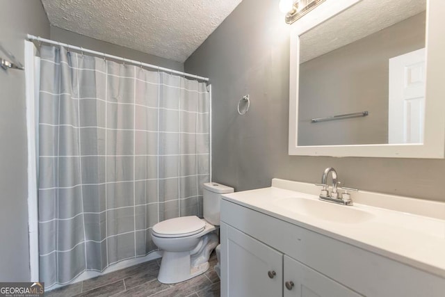 bathroom featuring curtained shower, wood-type flooring, a textured ceiling, toilet, and vanity