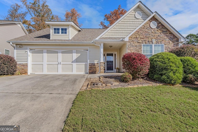 view of property featuring a garage and a front lawn