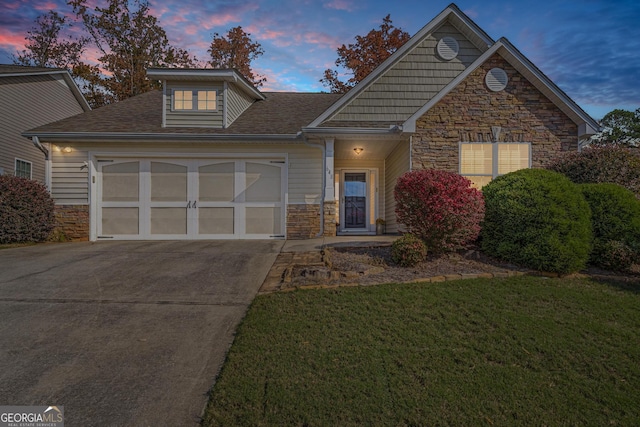 view of front property with a garage and a yard