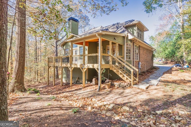 back of house with a wooden deck