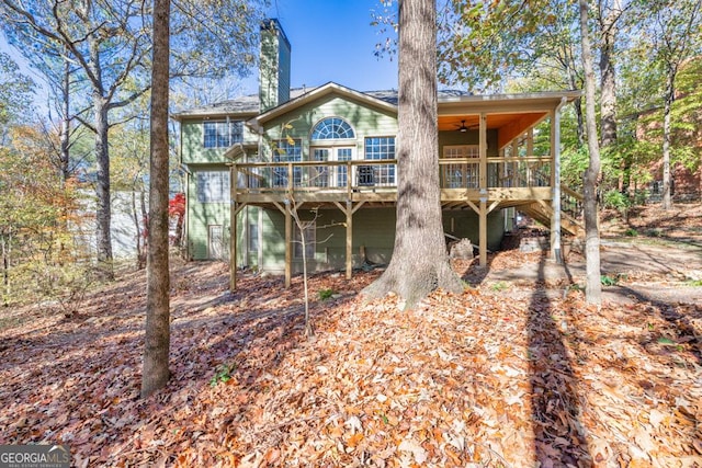 rear view of house featuring a deck and ceiling fan