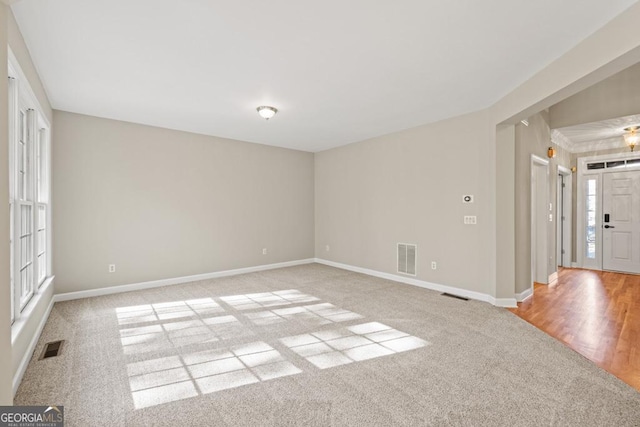 spare room with light hardwood / wood-style flooring and plenty of natural light