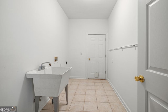 laundry room with hookup for an electric dryer, hookup for a washing machine, light tile patterned floors, and sink