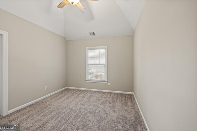 carpeted empty room with ceiling fan and vaulted ceiling