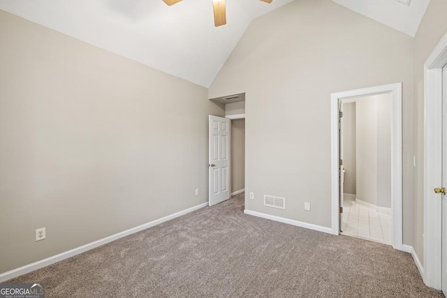 unfurnished bedroom featuring carpet flooring, high vaulted ceiling, and ceiling fan