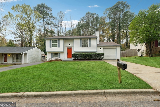 raised ranch featuring a garage and a front yard