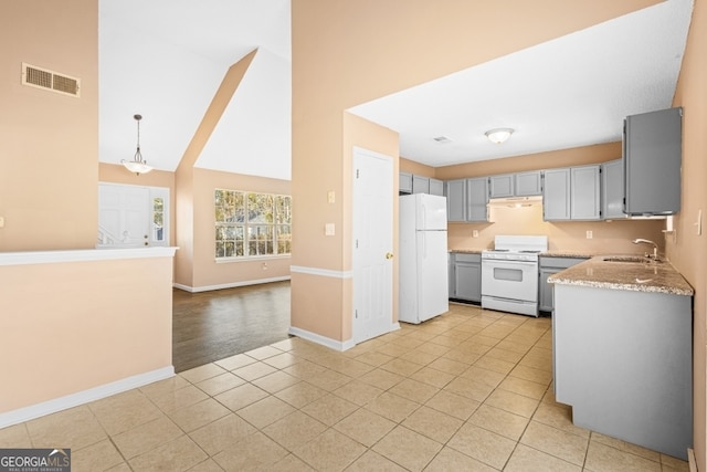 kitchen with pendant lighting, lofted ceiling, white appliances, sink, and gray cabinets