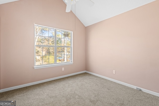 carpeted spare room featuring ceiling fan and vaulted ceiling