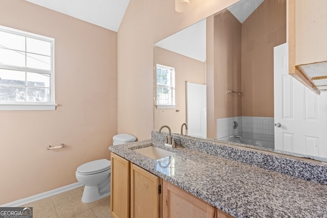 bathroom with tile patterned flooring, a textured ceiling, lofted ceiling, a bathtub, and vanity