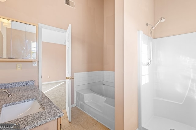 bathroom with plus walk in shower, vanity, and tile patterned floors