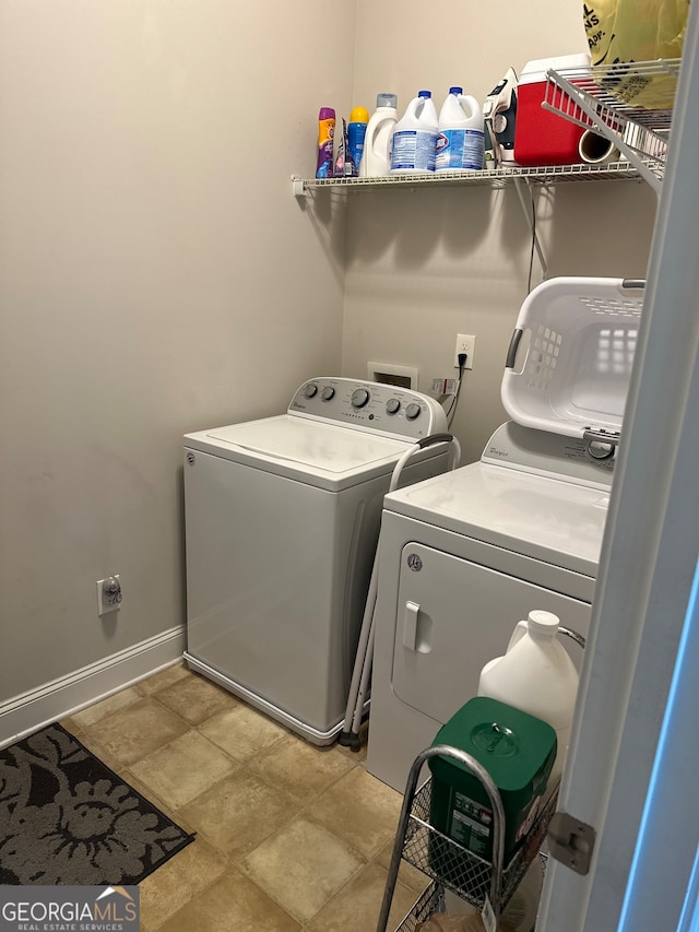 clothes washing area with washer and clothes dryer