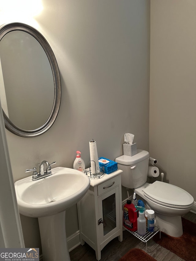 bathroom with hardwood / wood-style floors and toilet