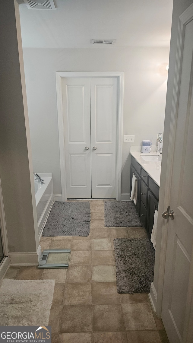 bathroom with vanity and a tub to relax in