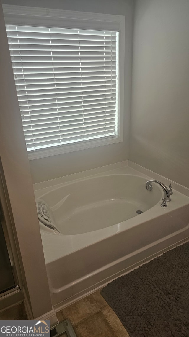 bathroom featuring tile patterned flooring and a bathtub