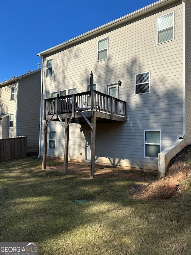 rear view of house featuring a yard