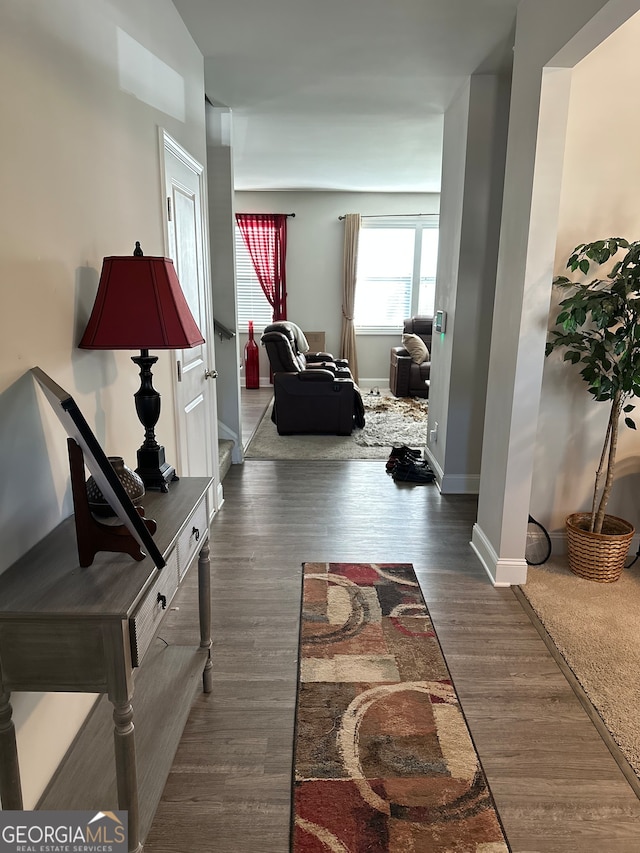 corridor with dark hardwood / wood-style flooring