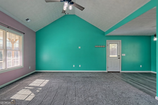 carpeted spare room with baseboards, visible vents, a ceiling fan, and lofted ceiling