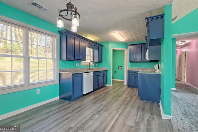 kitchen featuring white dishwasher, light hardwood / wood-style flooring, and blue cabinets